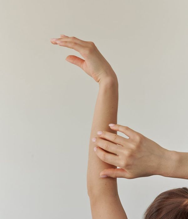 Woman in a graceful yoga pose with sky-blue light accents.